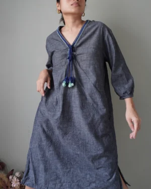 a bluish gray linen casual dress with functional pockets and the prettiest tassel deets