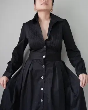 Old-money rich black long sleeved button down dress that has a flattering waist fit