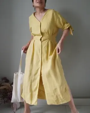 Lemon button down linen dress with sleeves that has knot accents, side slits and just the perfect easy summer dress