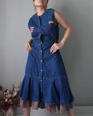 vintage denim dress with button down details, has nice flowy finish, inner lining is a beautiful semi corduroy floral patterned fabric