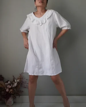 White linen dress with ruffled neckline details