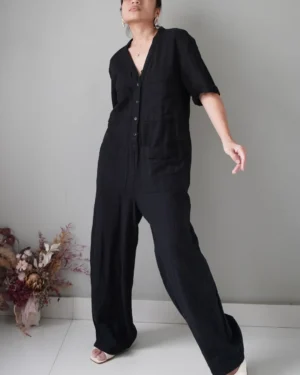 Black linen romper with pockets, swipe for flaw